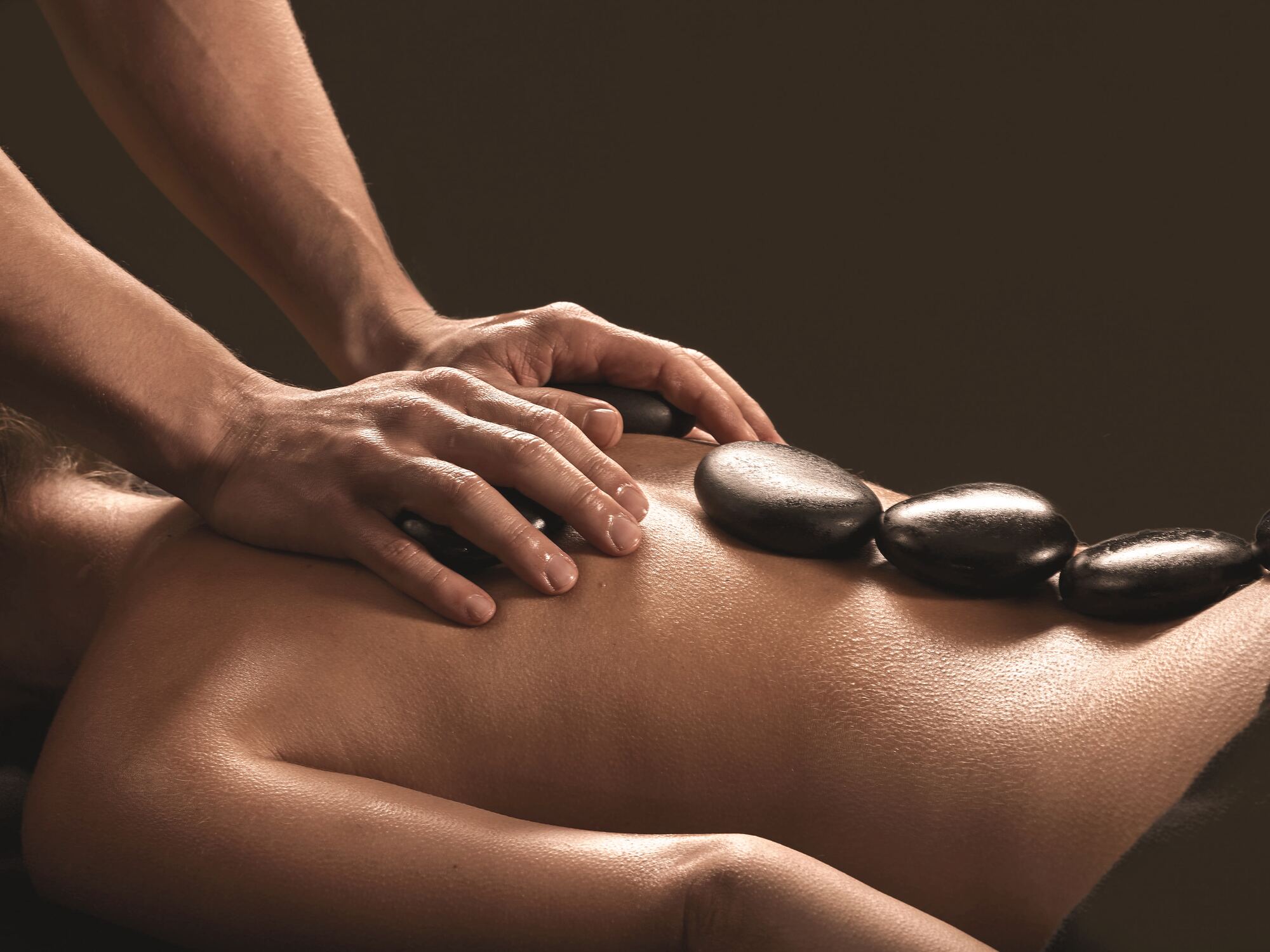 Warme basaltstenen op de rug tijdens een hotstone-massage
